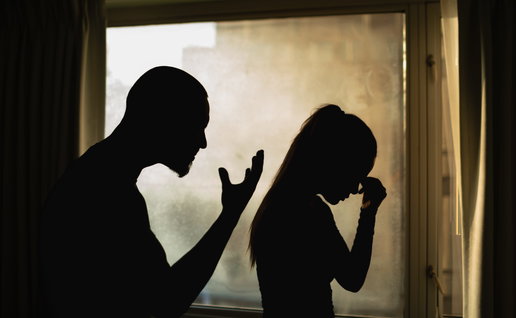 The silhouette of man yelling at a woman