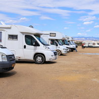 Caravans parked on the shore at a beach in Spain
