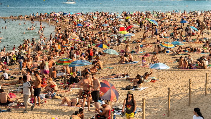 Crowded beach parasol hogging.
