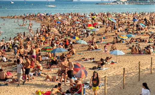 Crowded beach parasol hogging.