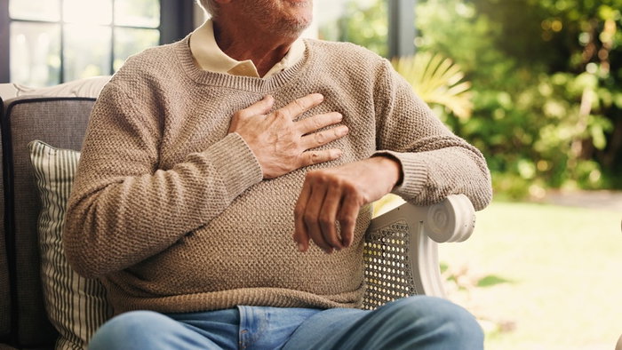 Hands, senior man and chest pain at house from cardiac attack, heart failure and hypertension. Discomfort, elderly person or symptoms of asthma, breathing issues and backyard with respiratory illness