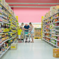 A family shopping in a supermarket aisle