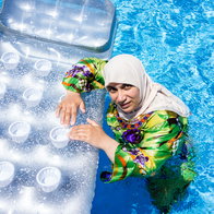 Burkini-wearing woman in pool.