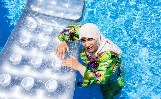 Burkini-wearing woman in pool.