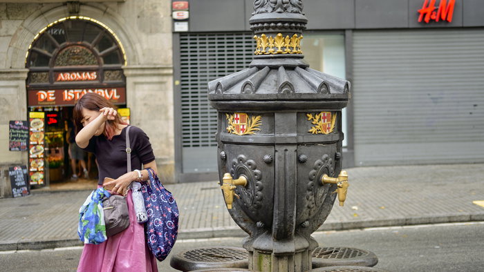 woman drinking from Barcelona water fountain