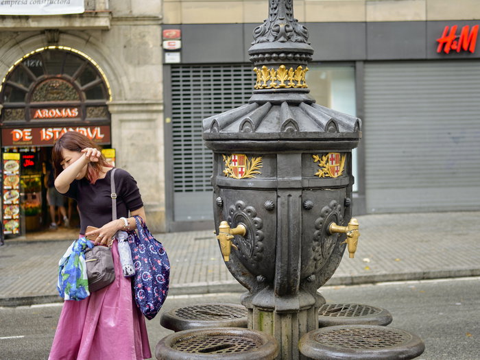 woman drinking from Barcelona water fountain
