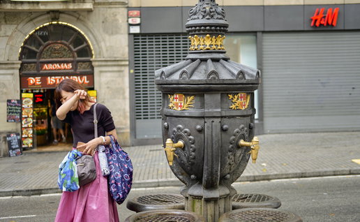 woman drinking from Barcelona water fountain