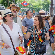 Tourists walking near Banco de España metro station in Madrid, enjoying a visit to the Spanish capital.