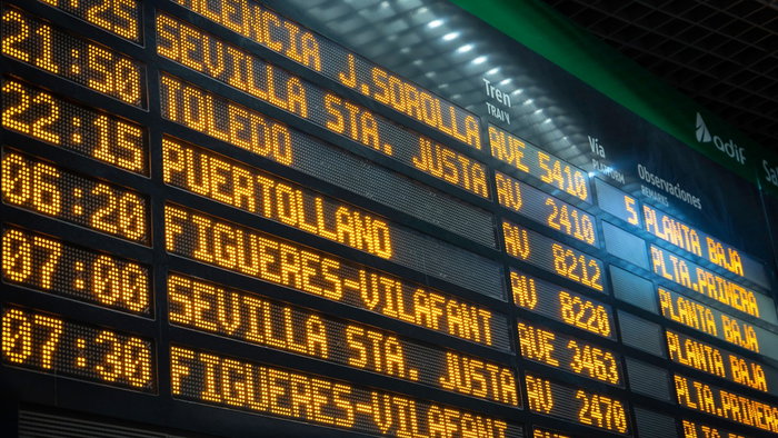 Electronic departures board displaying Renfe train services inside a Spanish railway station ahead of the planned rail strike on 15 July.
