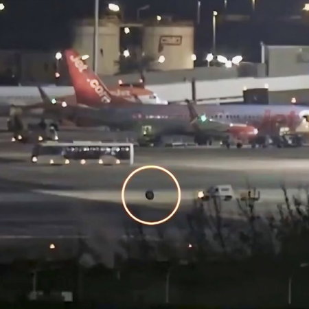 Errant wheel rolls away from Ryanair plane, chased by van.