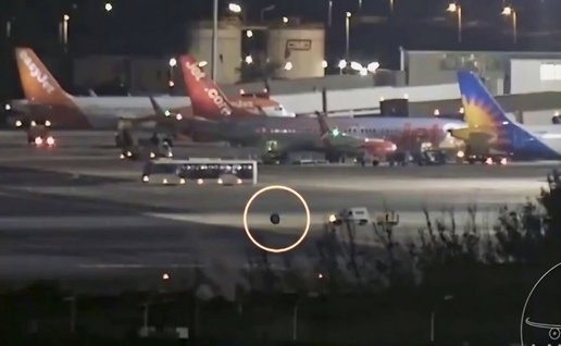 Errant wheel rolls away from Ryanair plane, chased by van.