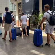 Tourists arriving in Malaga with trolley cases.