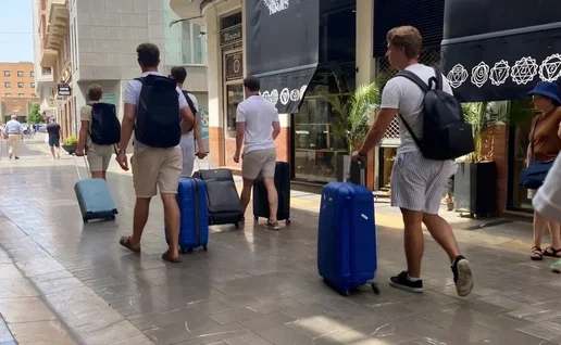 Tourists arriving in Malaga with trolley cases.