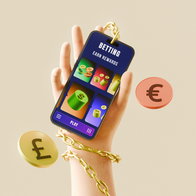 View of a hand holding a mobile phone with gold type chaing attached and around the wrist