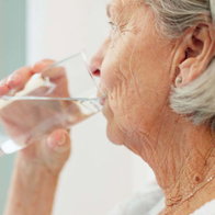 Healthy, hydration and senior woman drinking water for wellness and liquid diet detox at home.