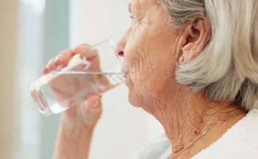 Healthy, hydration and senior woman drinking water for wellness and liquid diet detox at home.
