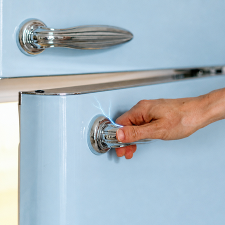 Hand gets electric shock from appliance.