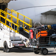 Pile of bags about to be loaded onto an aircraft.