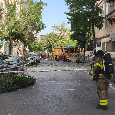 A firefighter securing an area after a building crumbles in Granada