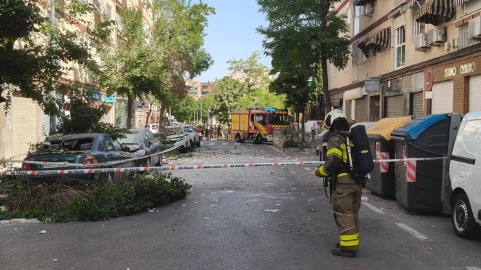 A firefighter securing an area after a building crumbles in Granada