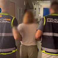 Accused 'fake' lawyer taken away by police at Malaga Airport.