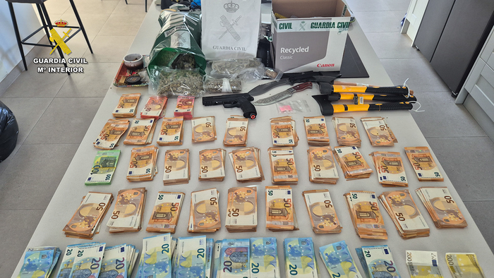 Money and other objects spread out on a table, seized by the Guardia Civil during the Tenerife raids.