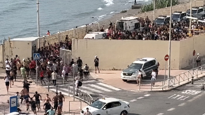 Thousands of immigrants flood Spanish gates in Ceuta in July.