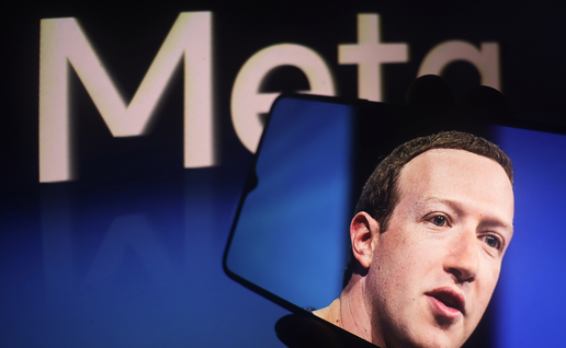 Mark Zuckerberg picture on a phone in front of a Meta sign.