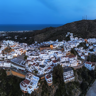 Aerial night view of Mojácar's hillside town lit up above the Almería coastline