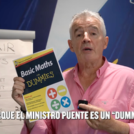 Michael O'Leary holding a book called "Math for Dummies" in front of a Ryanair branded wall during his speech in a recent YouTube video.