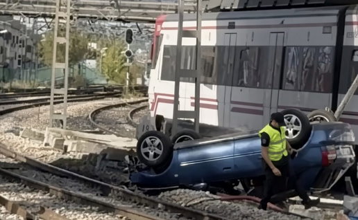 Car topples off bridge and into way of trains.