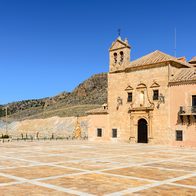 Exterior of the Santuario del Saliente church and plaza near Albox, Almería, with mountains behind.