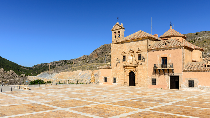 Exterior of the Santuario del Saliente church and plaza near Albox, Almería, with mountains behind.