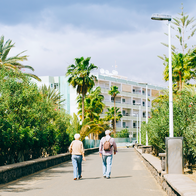 Two pensioners walking down a footpath in Spain