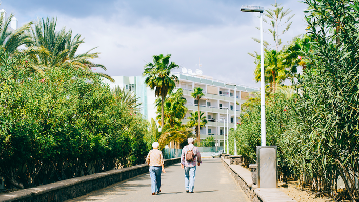 Two pensioners walking down a footpath in Spain