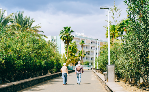 Two pensioners walking down a footpath in Spain