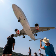 People watch and take photos of a Volotea Airbus A320 (EC-NQN) as it lands