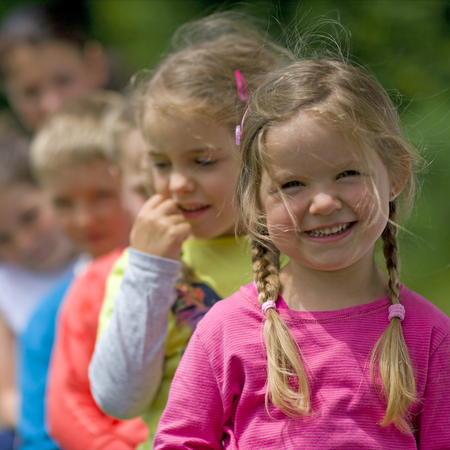 children in a garden staring at the camera