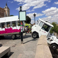 A tourist train that has invaded the pavement and smashed through a wall