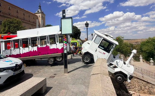 A tourist train that has invaded the pavement and smashed through a wall