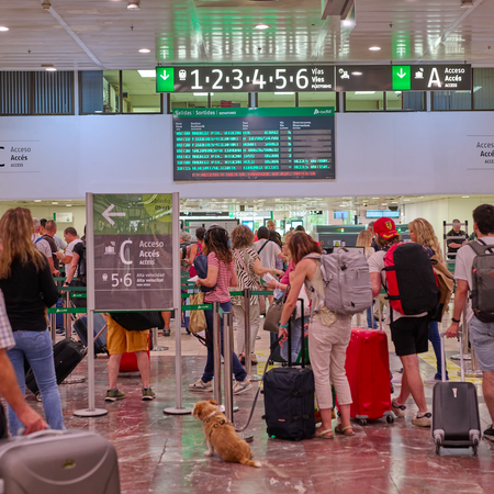 Passengers queue at El Prat airport in Barcelona.