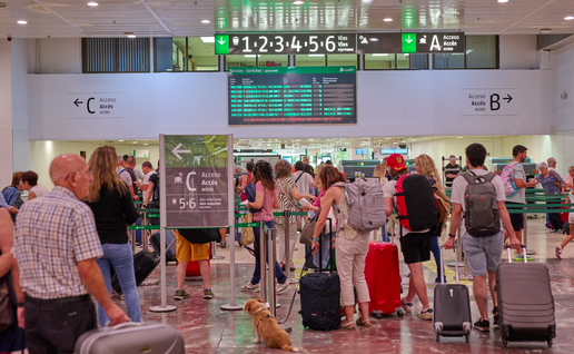 Passengers queue at El Prat airport in Barcelona.