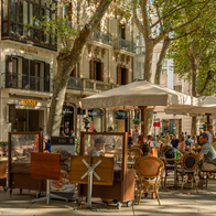 General view of the Paseo del Borne in the historic center of Palma de Mallorca at sunset. Terrace of cafes with customers having a drink