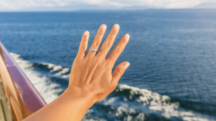 Hand with engagement ring.