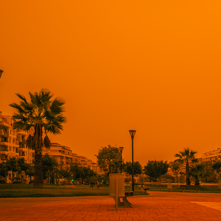 A village with a red sky caused by Saharan Sand
