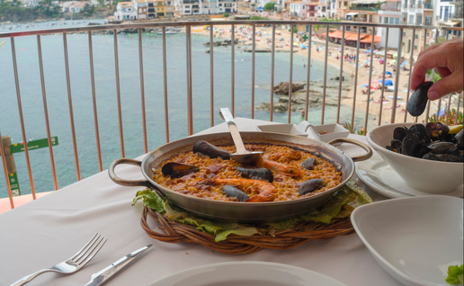 A traditional paella at a beach front restaurant accompanied with a bowl of mussels