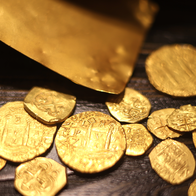 Gold coins spread out on a table.