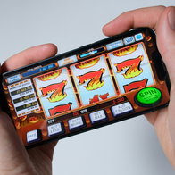 View of a person holding a slot machine reel in 2 hands