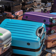 Many suitcases piled up one on top of another.