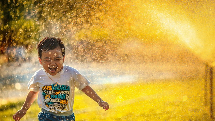 A boy playing in the water.